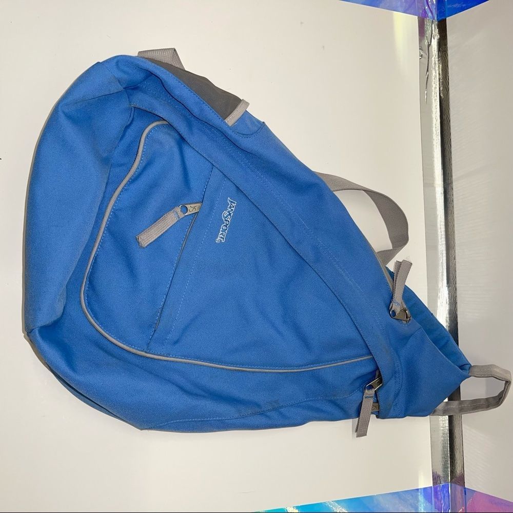 { Jansport Baby Blue Sling Backpack lots of Pockets!